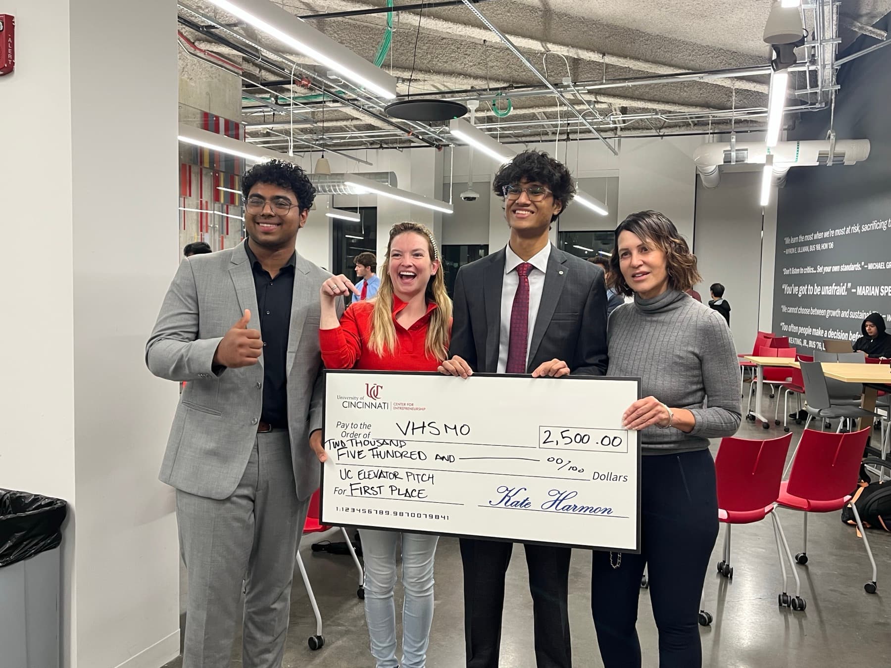 The team celebrating VHSMO's first cheque with their mentors